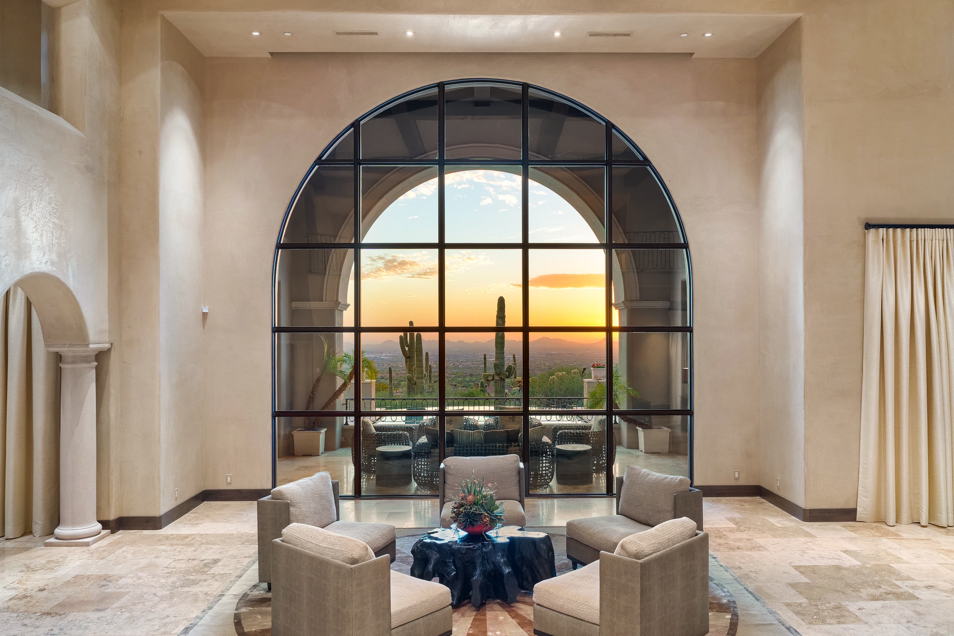 Grand arched window with desert sunset — Paradise Valley luxury home interior