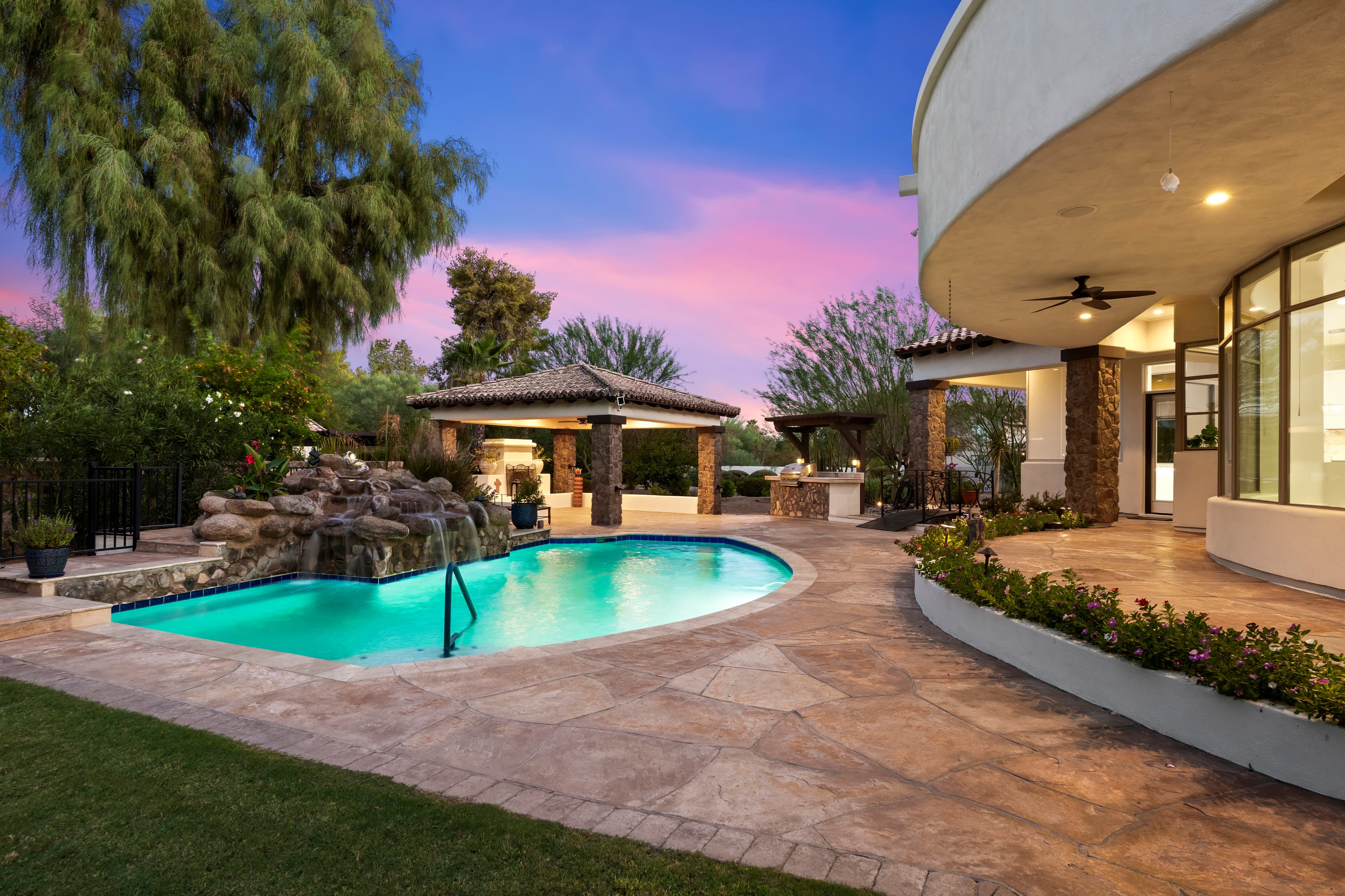 Resort-style pool at twilight — Scottsdale luxury home backyard